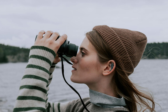 Woman with a brown hat while Maui whale watching in December.