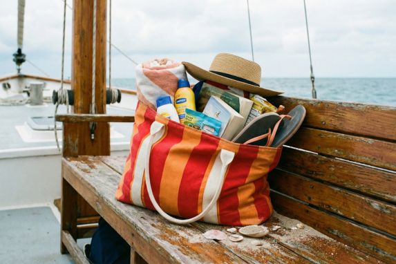 Tote bag that has been overpacked with unneeded items.